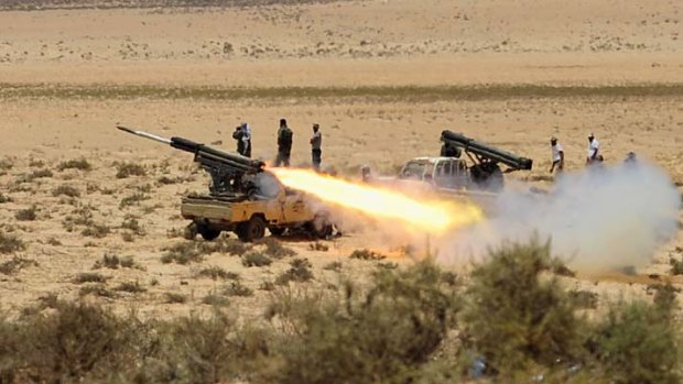 Rebel forces fire artillery at Libyan government troops outside the town of Ajdabiyah, in the north-east of the country, on Monday.