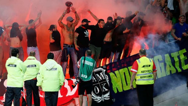 Rogue element:  Wanderers fans let off flares during the match against the Victory in Melbourne last month.