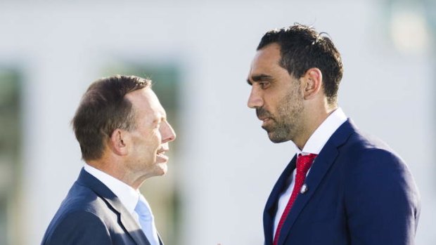 Australian of the Year Adam Goodes is presented the award by Prime Minister Tony Abbott.
