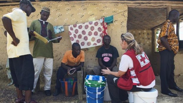 Red Cross volunteer nurse Libby Bowell talks to villagers in Liberia.