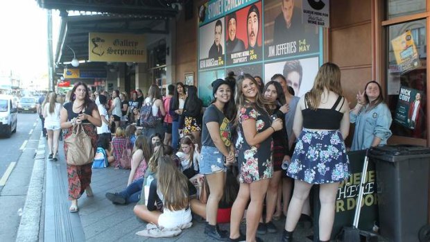 Fans queue outside the Enmore Theatre before a show by Australian boy band Five Seconds Of Summer.