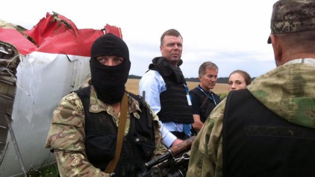 Alexander Hug (second from left), Deputy Chief Monitor of the Organisation for Cooperation and Security in Europe's  (OSCE) Special Monitoring Mission to Ukraine, surrounded by heavily armed pro-Russia rebels at the crash scene.