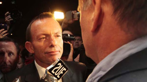Here's looking at you: Tony Abbott is confronted by "journalist" Mark Latham at the Penrith RSL Club yesterday. <i>Picture: Glen McCurtayne</i>