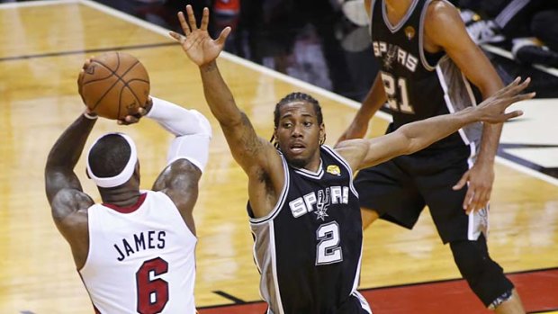 Key man for the key moments: LeBron James shoots a crucial basket near the end of Game 7 as Kawhi Leonard tries to block him.