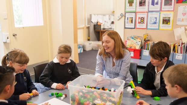 Sum total of effort and passion: Lumen Christi Catholic Primary School teacher Cassandra Lowry delights in maths. Here she is helping her year 3 extension program students. 