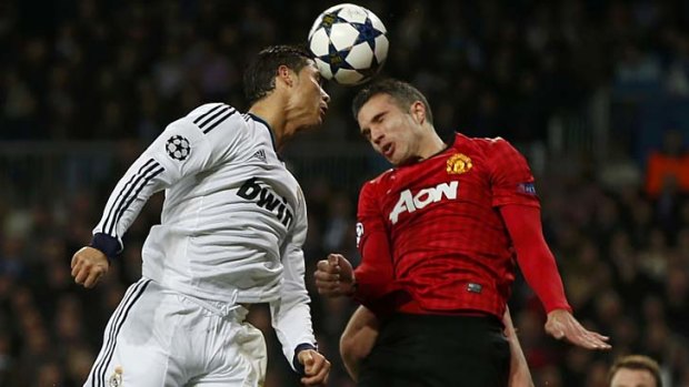 Manchester United's Robin van Persie challenges Real Madrid's Cristiano Ronaldo.