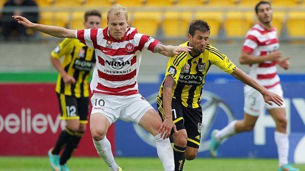 Aaron Mooy of the Wanderers holds off Vince Lia of the Phoenix.