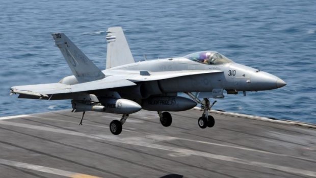 This US Navy handout shows an FA-18C Hornet land on the USS George H.W. Bush.