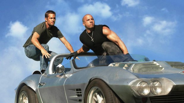 Paul Walker and Vin Diesel in scene from one of the <i>Fast & Furious </i>films.