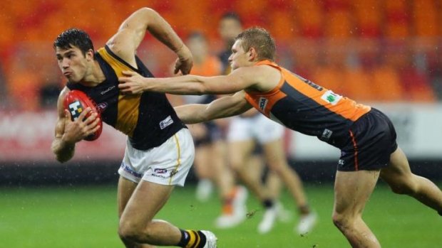 Tiger Alex Rance is almost caught by Giant Adam Treloar in this 2012 encounter between the two clubs.