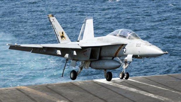 Returning safely ... A US Navy F/A-18F Super Hornet lands on the aircraft carrier USS George H.W. Bush in the Persian Gulf.