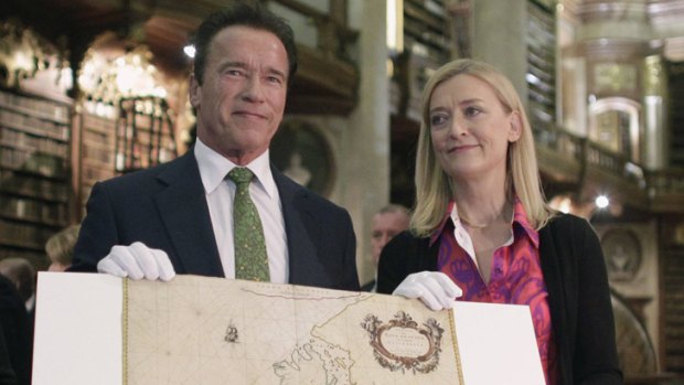Former California governor Arnold Schwarzenegger and director of the Austrian National Library Johanna Rachinger with a historic map of California from 1666 in Vienna.