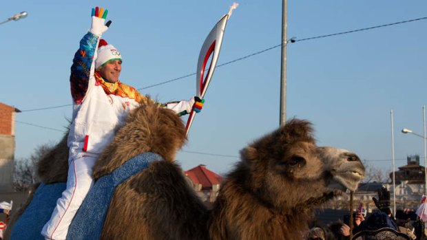A torchbearer riding a camel in the Russian Caspian Sea port of Astrakhan.