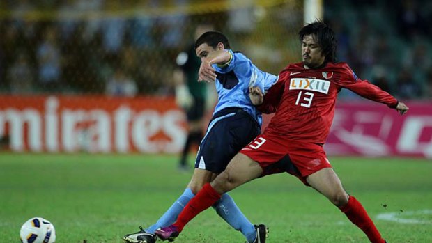 Sydney FC's Stuart Musialik is tackled by Shinzoh Kohrogi of the Kashima Anters.