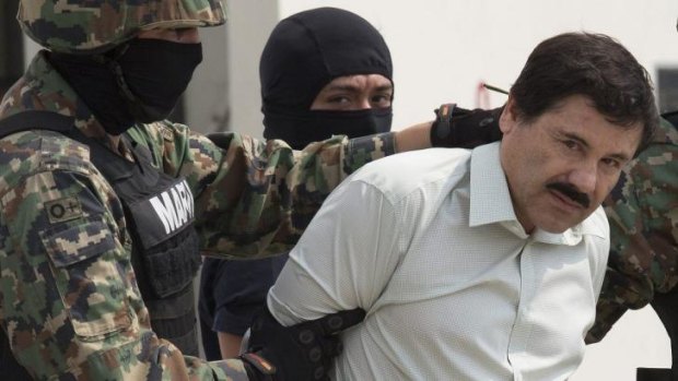 Finally captured ... drug trafficker Joaquin "El Chapo" Guzman is escorted to a helicopter by Mexican security forces at Mexico's International Airport in Mexico city.