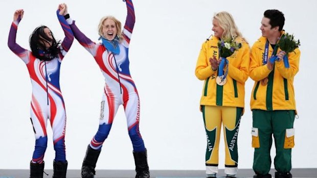 Jessica Gallagher with guide Christian Geiger watch on as Henrieta Farkasova (L) of Slovakia celebrates winning the gold medal. Gallagher won Australia's second bronze medal of the Games.