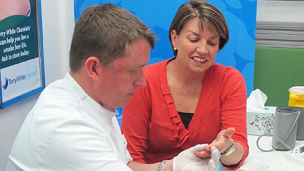 Queensland Premier Anna Bligh having a diabetes fingerprick test.