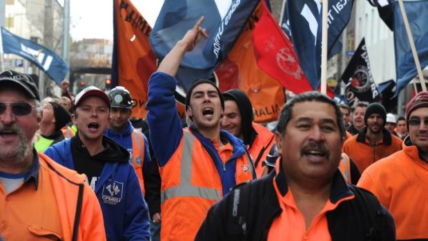 Melbourne building workers rally outside Parliament House yesterday to protest against a new industry code of conduct, which began on Sunday.