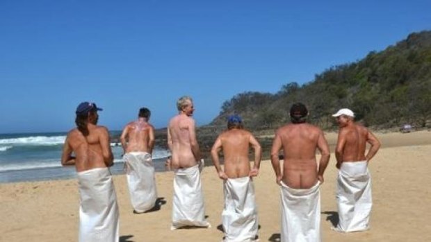 Competitors enjoy the sack race during Nudist Day at Alexandra Beach.