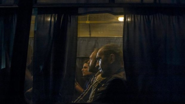 Bargaining chips: Men traded for Ukrainian prisoners ride a bus near Yasinovataya.