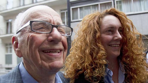 News Corporation CEO Rupert Murdoch leaves his flat with Rebekah Brooks, chief executive of News International.