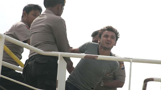 The voyage ends in heartache and frustration ... an asylum seeker is forced off his boat in the Indonesian port of Merak in April.