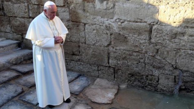 Pope Francis prays at Bethany on the River Jordan, where some Christians believe Jesus was baptised.