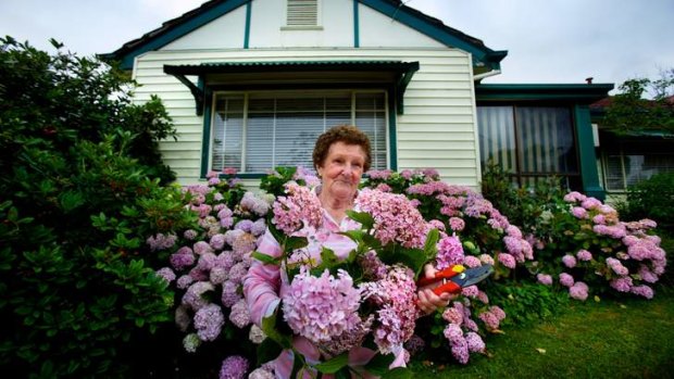 Unsentimental: Joan Williams in the garden of her Essendon, post-World War II, weatherboard home, which she says has ''done its time''.