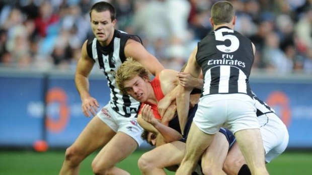 Thrown to the wolves: Jack Watts is monstered by Collingwood.