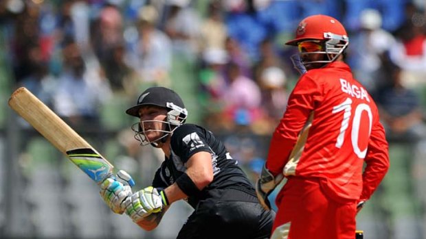 Brendon McCullum plays a ball to square leg as Canadian wicketkeeper and captain Ashish Bagai looks on.