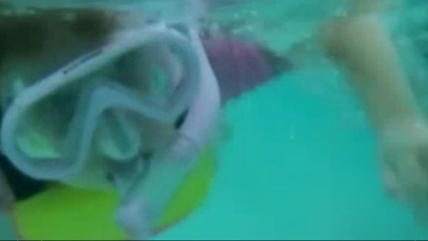'Life's too short' ... Anaia Barnes, 5, is filmed swimming with sharks on a family holiday.