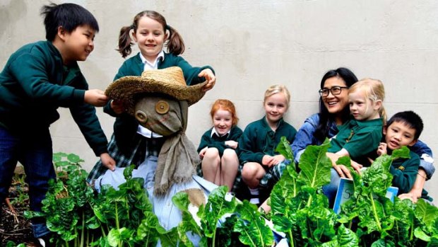 Sprouting some fund-raising ideas &#8230; students from Crown Street Public School, with chef Kylie Kwong from Billy Kwong's, dress the scarecrow in the school's veggie patch.