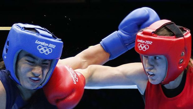 She gives it ... Ireland's Katie Taylor of Ireland (right) on the attack against Mavzuna Chorieva of Tajikistan.