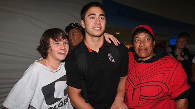 Shaun Johnson of the Warriors poses with fans as he arrives in Auckland on Sunday.