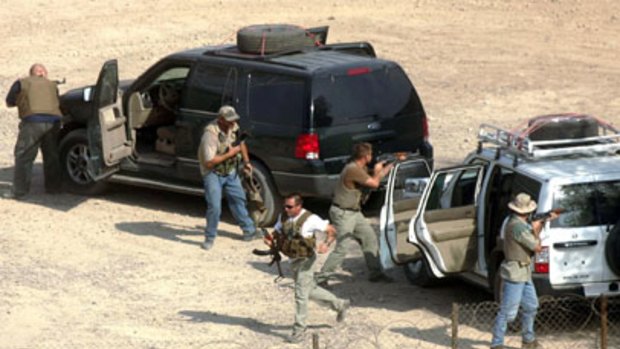 Guns for hire ... foreign private security contractors staging a drill in Baghdad in 2004.