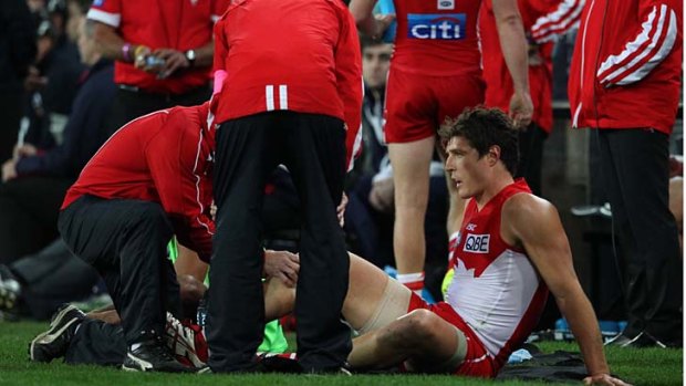 Kurt Tippett being attended to after he was injured in the semi-final against Carlton.
