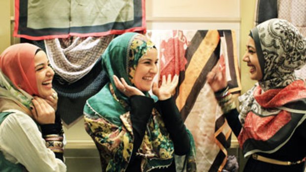 Looking good... Mouna Fattouh, her sister Ruby and Manaal Fatima, from left, try on the latest prints at Hajib House in Centro Mall, Bankstown.