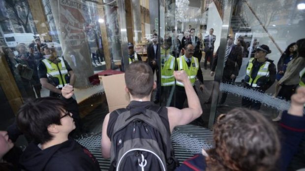 Students protest outside Melbourne University on Friday, waiting for a visit from Prime Minister Tony Abbott