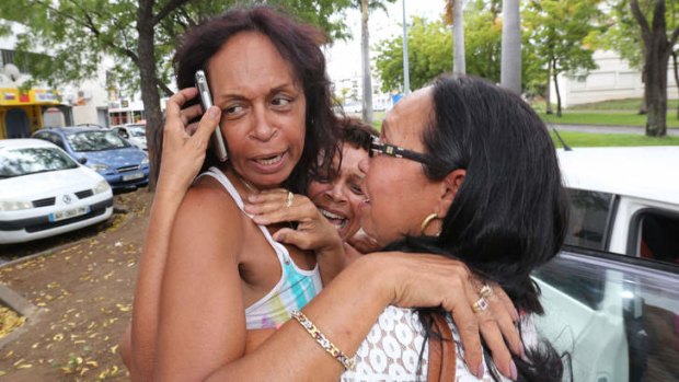 The wife of former French hostage Francis Collomp, Anne-Marie Collomp (left), reacts with her sisters after the announce of the release of her husband.