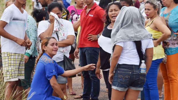 Relatives wait for information on the welfare of inmates, outside the Agricultural Penitentiary of Monte Cristo.