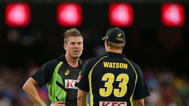 Australia's James Faulkner left and Shane Watson talk during their T20 International cricket match against India in Adelaide.