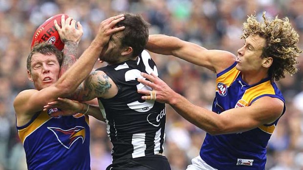 Collingwood's Dane Swan is squashed between two West Coast players at the MCG.