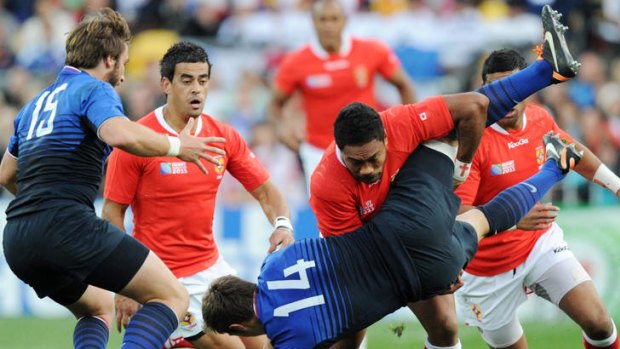 Tonga's Sukanaivalu Hufanga upends France's Vincent Clerc.