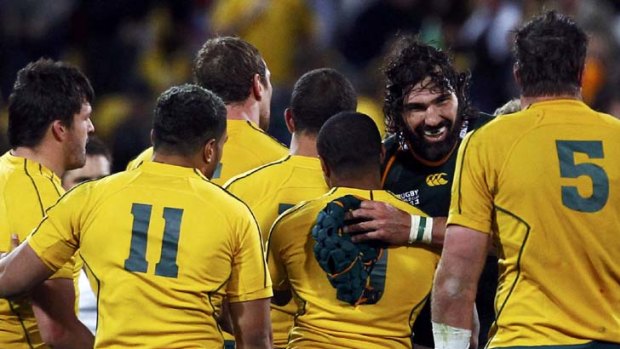 Tackled themselves into a frenzy ... Victor Matfield congratulates exhausted Wallabies players after the final whistle.