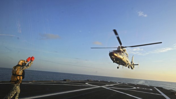 A Dolphin Z-9 helicopter of China's Navy missile frigate CNS Yulin flies off the deck of Singapore's Navy missile frigate RSS Intrepid in the South China Sea on May 25.