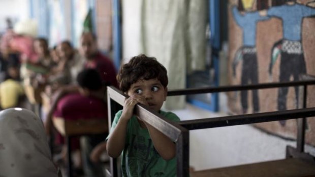 A displaced Palestinian child takes shelter at the UN school in the Jabalia refugee camp after the shelling.