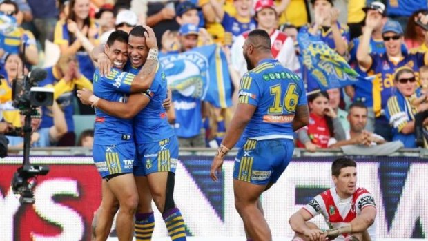Record margin: Ken Sio (left),  Will Hopoate  (middle) and Pauli Pauli celebrate beating the Dragons.