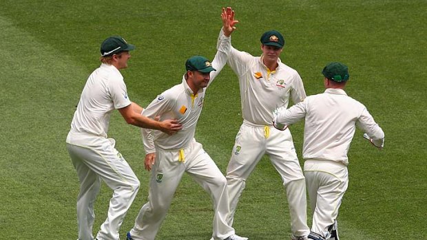 Michael Clarke is congratulated by team mates after taking the catch to dismiss Alastair Cook.