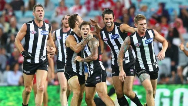 Jamie Elliot of the Magpies celebrates a goal with his teammates during the round 2 game against the Sydney Swans at ANZ Stadium on Saturday.