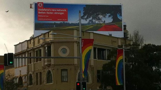 A billboard on Oxford Street in Sydney showing a Vodafone advertisement.